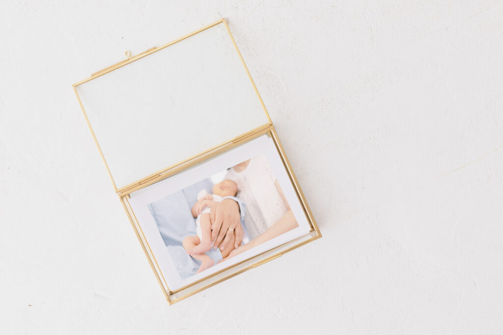 newborn photo prints encased in glass box