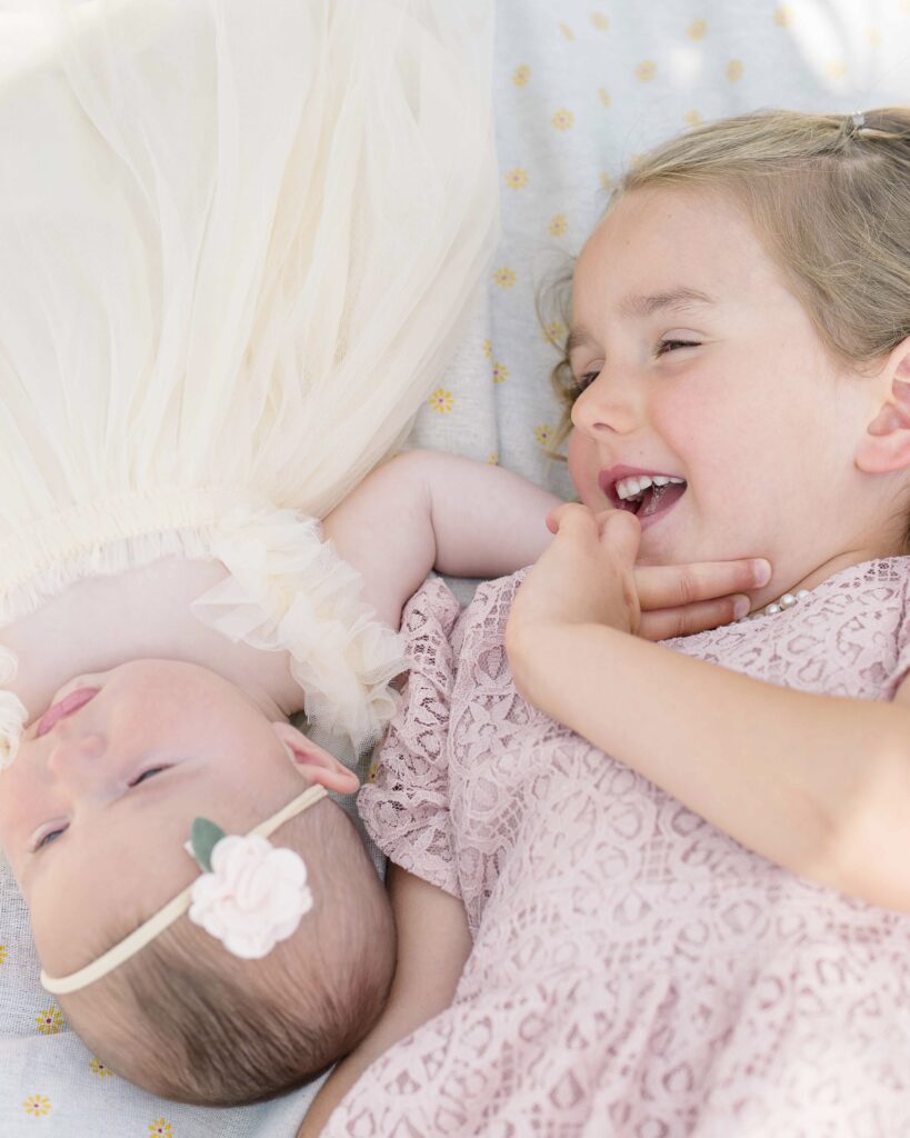 newborn photo with sister in san diego