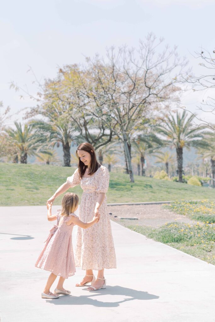 a woman and a child holding hands