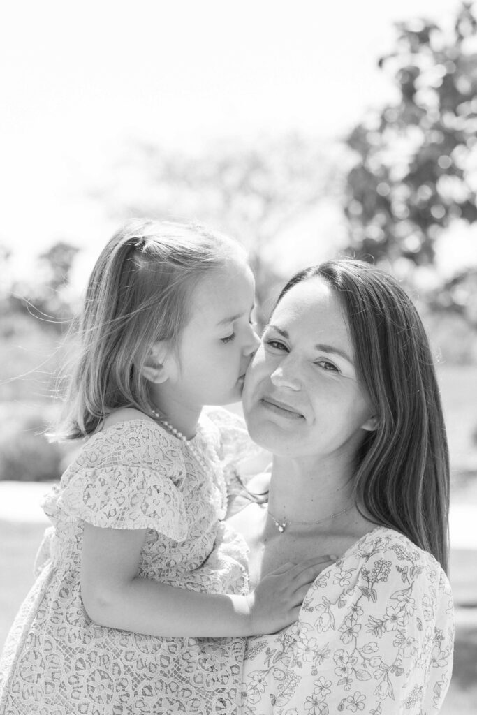 a woman and a child kissing