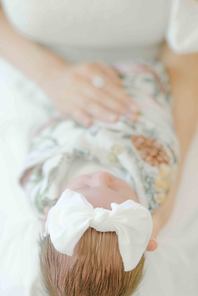 san diego newborn photoshoot with baby napping in mom's lap