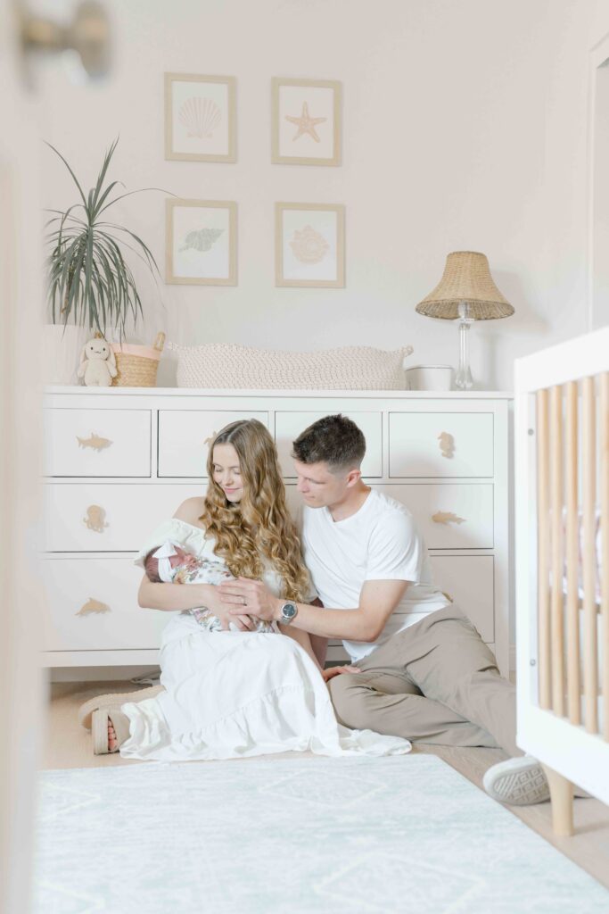 san diego baby nursery design with parents holding baby girl