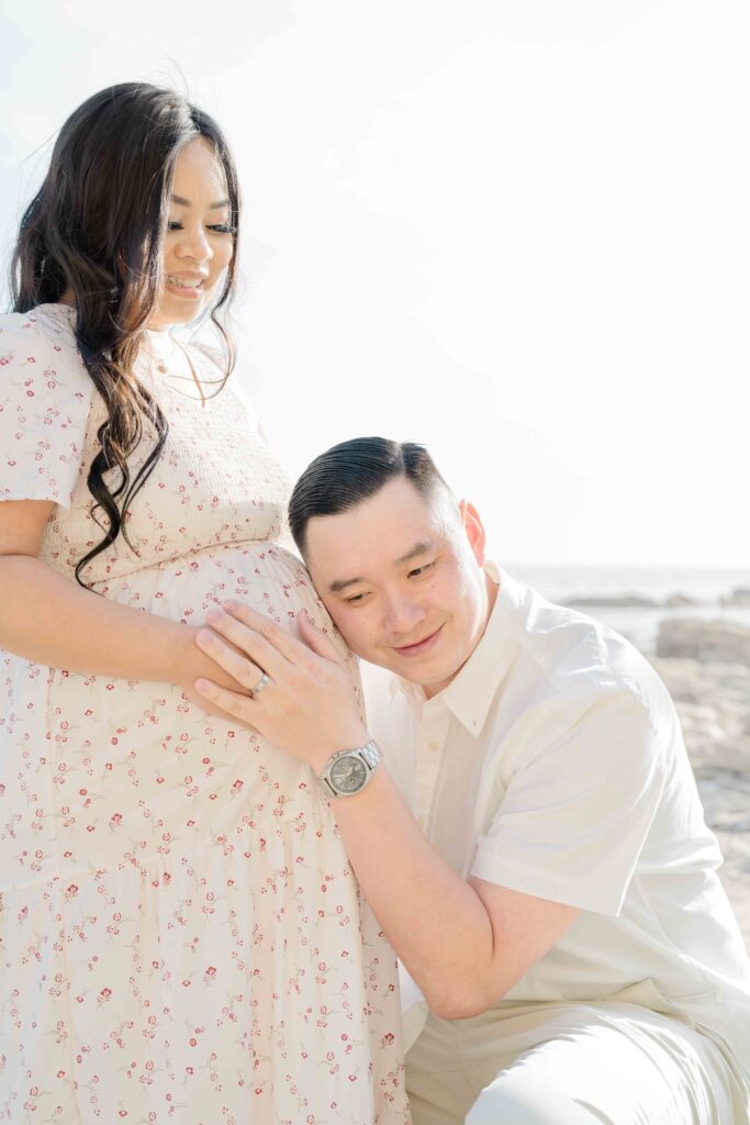 Dad smiling when he heard son's heartbeat in mom's belly