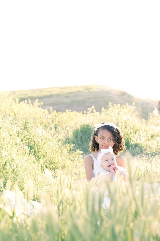 sister poses outdoor in field